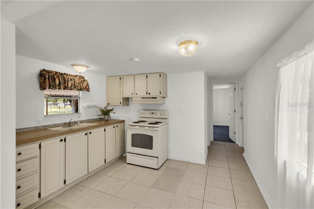 Kitchen Offers Tile Flooring and Breakfast Nook