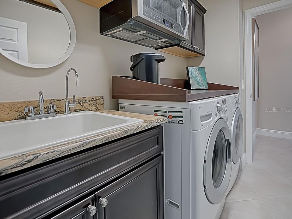 LAUNDRY ROOM WITH GRANITE, BUILT-IN SINK, FRONT LOAD WASHER AND DRYER THAT DO CONVEY WITH THE HOME!