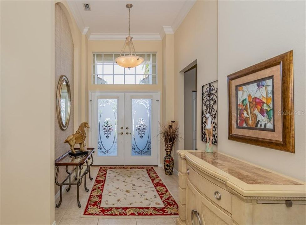 Elegant double door entry with 12 ft. ceilings, a large niche and crown molding.
