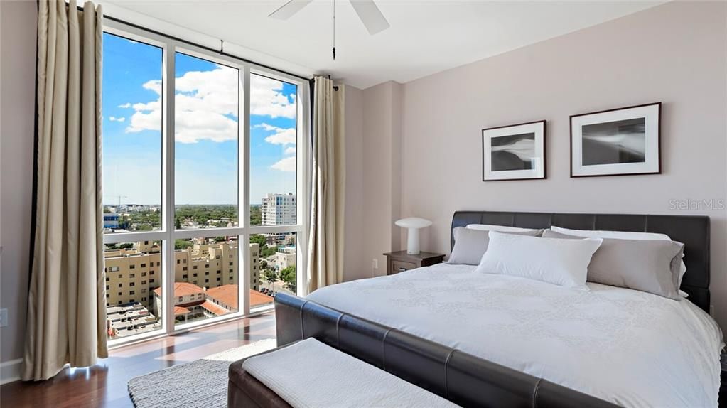 The owner's retreat bedroom with floor to ceiling views of the city to the west and the water to the east.