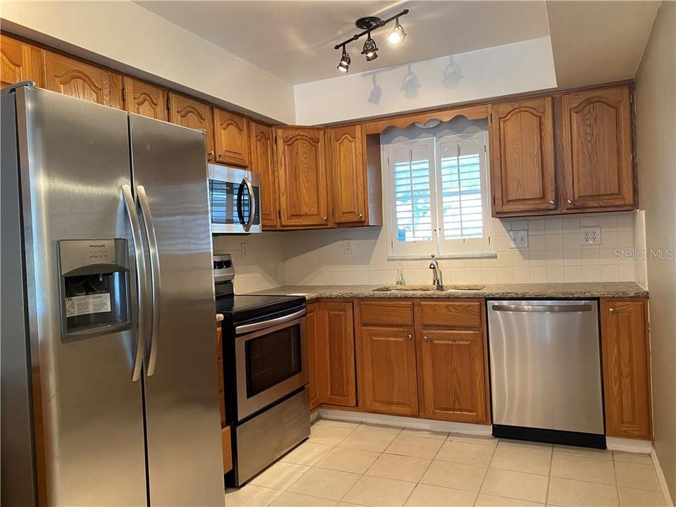 Kitchen with stainless steel appliances, wood cabinets, and so much more!