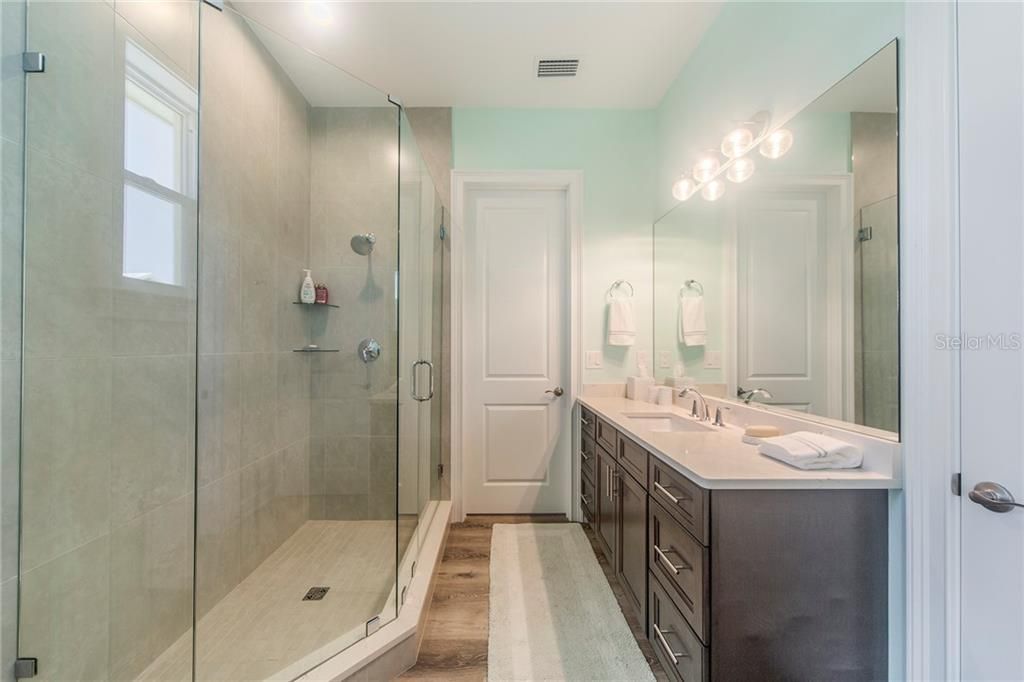An amazing Guest Bath, huge vanity and shower, large linen closet.