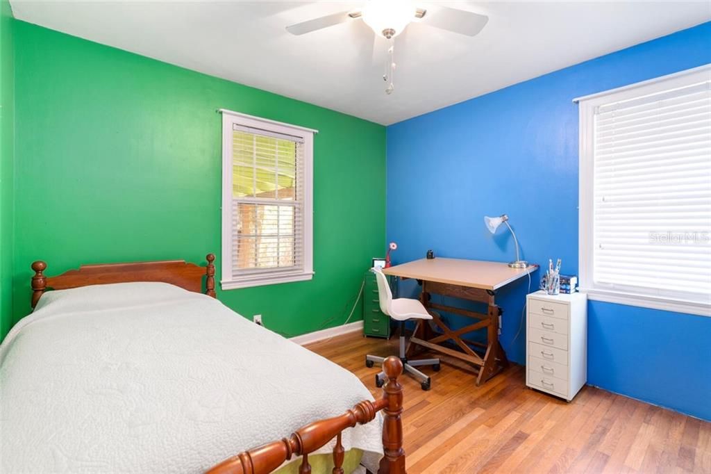 The second bedroom features gorgeous wood flooring and a ceiling fan too!