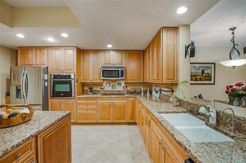 Built in oven and cooktop, breakfast bar, large adjacent laundry and storage.