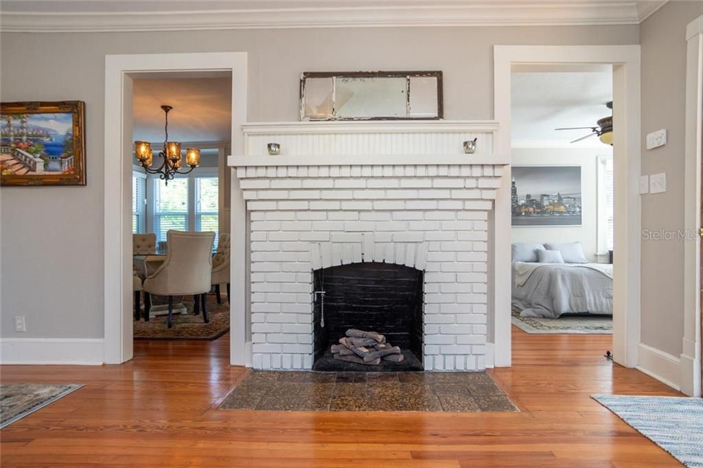 Wood burning fireplace in formal living room. Downstairs guest bedroom and formal dining room off of the living room