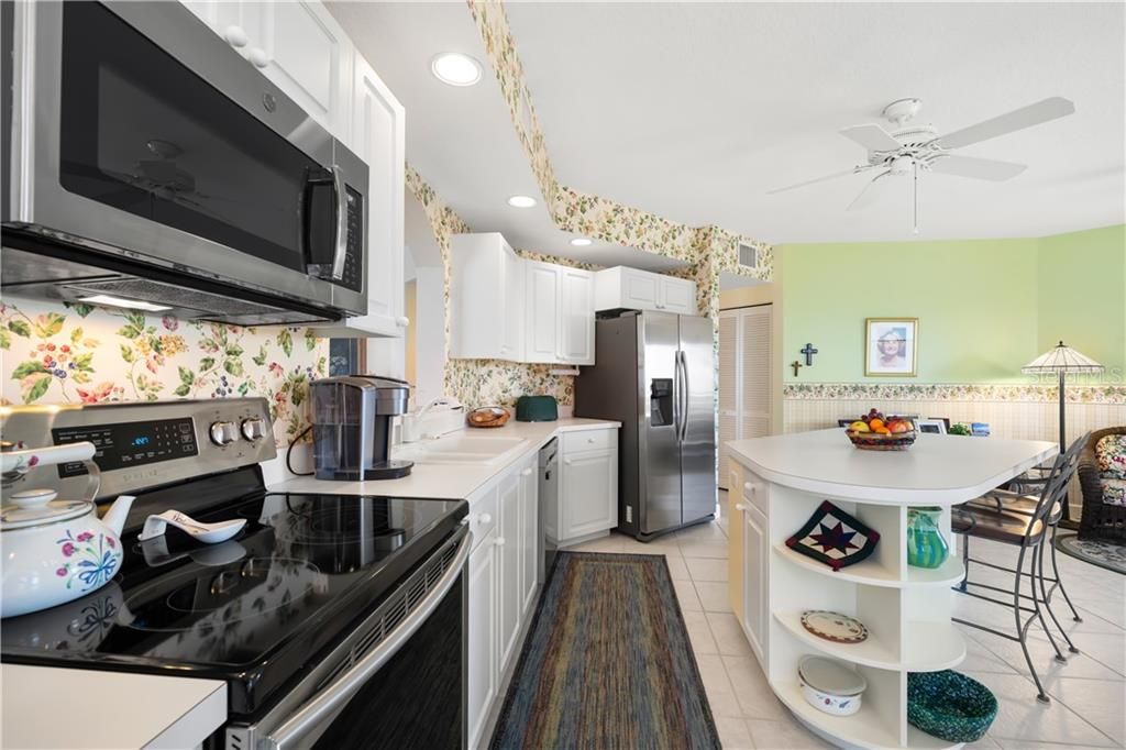 The large open kitchen is well equipped with newer appliances.