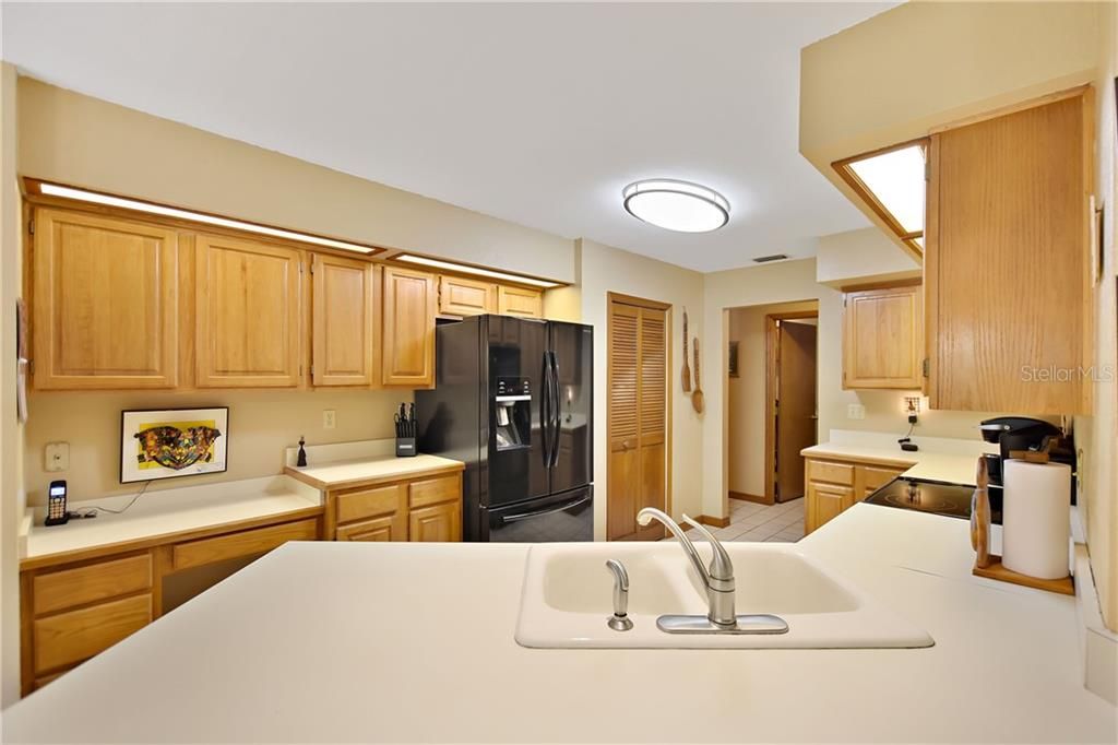 The kitchen has wood cabinetry, plenty of counter/work space and a large pantry.