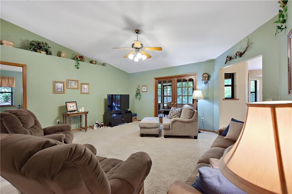 The Large 15' x 18'  living room is the center of the home with kitchen and dining room easily accessible from the hall way or the opening towards the back of the living room.  The cathedral ceiling makes this room feel even more spacious.