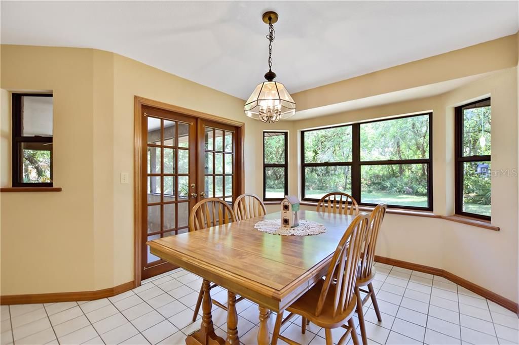 Dining room has lots of windows allowing natural light to filter into the home.  French doors lead to the screened lanai.  The dining room has ample space for hosting your next family get together.
