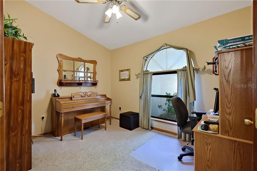 The den was built to accommodate the piano.  This room is designed to fit the homeowners needs - use it as a den, office, or add a closet and it's a 4th bedroom.
