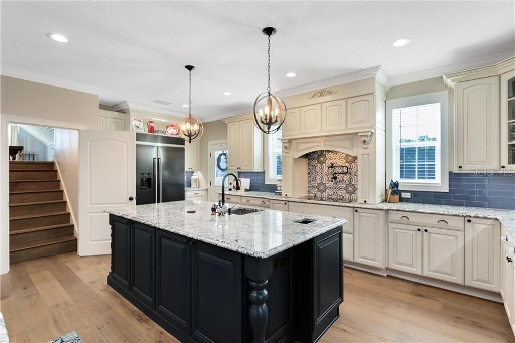 Custom Cabinetry, Side Door Leading to Driveway, Stairs to Game Room, 4th Bedroom, or Flexspace