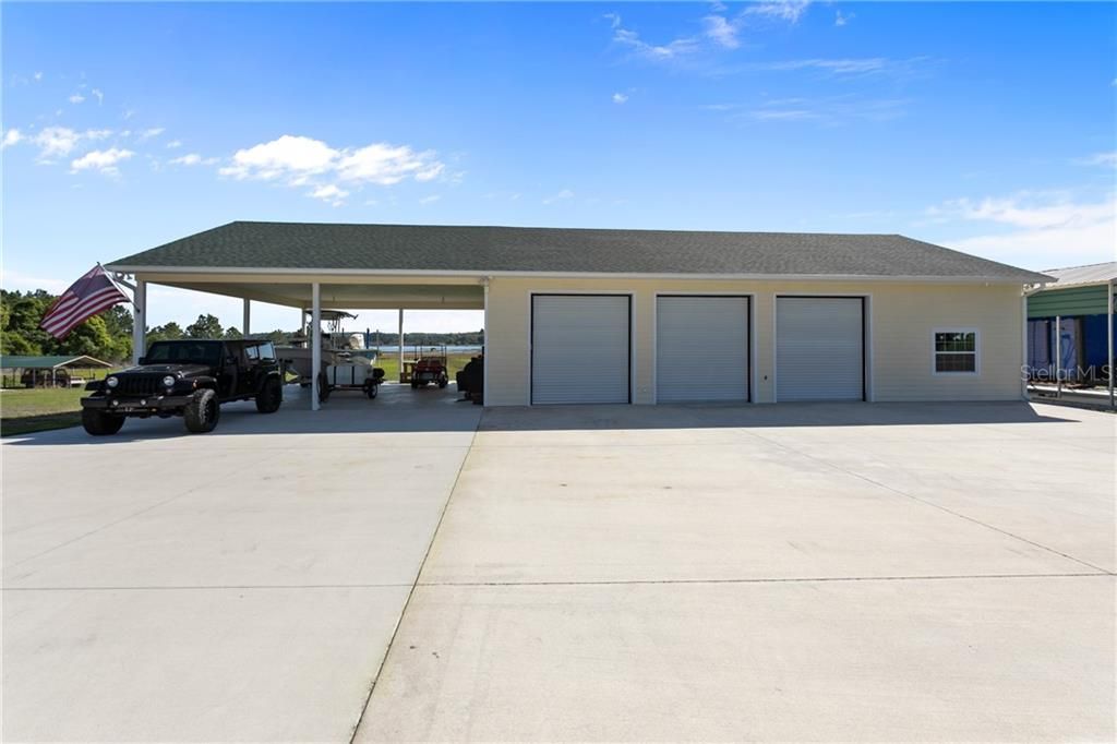 Outbuilding; Garage 2 with 3 Oversized Indoor Bays; 2 Oversized Carport Bays; Additional RV Covered Parking to the Right of Building