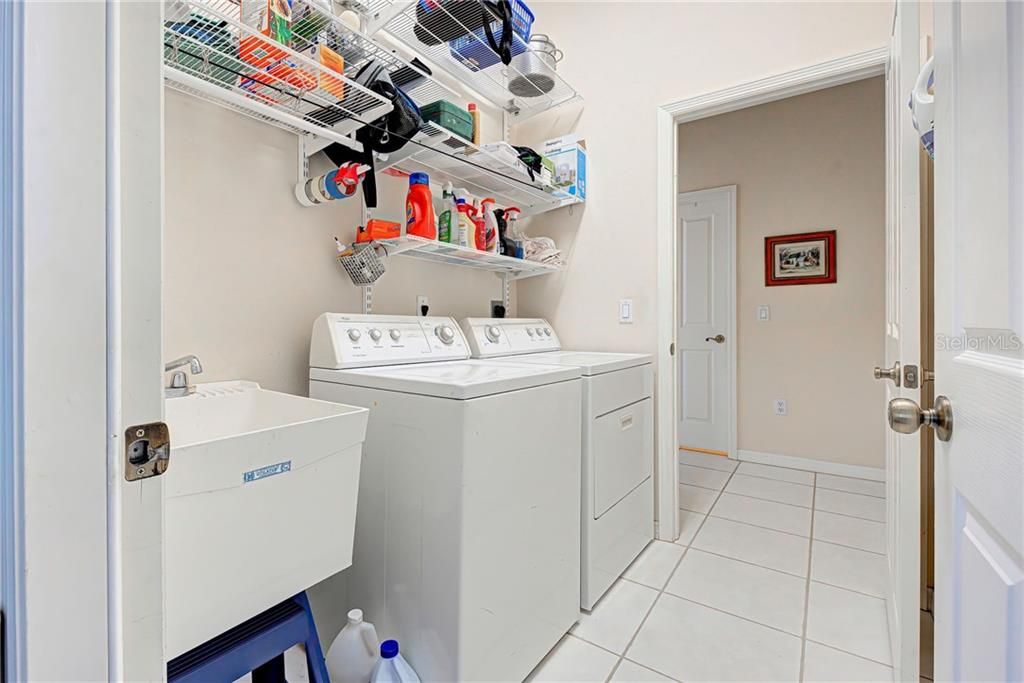 Interior laundry room with tub, from garage and into kitchen