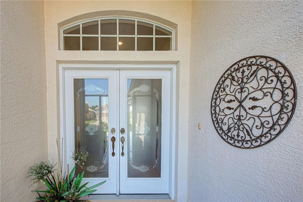 Gracious covered entryway with double doors to greet you