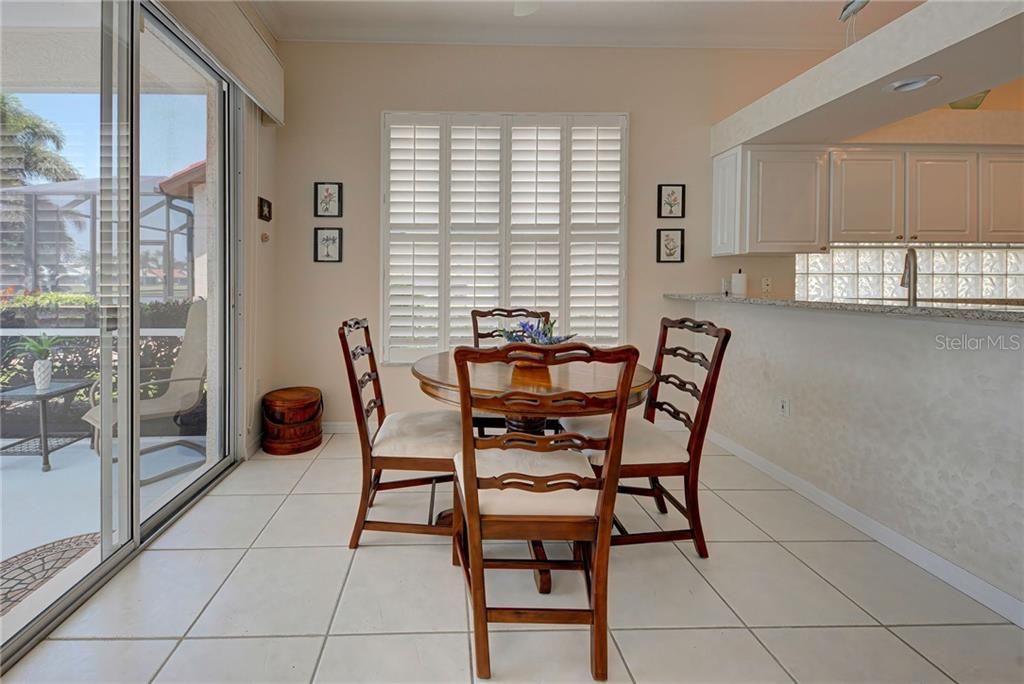 Convenient breakfast nook just off of kitchen leads to covered lanai.