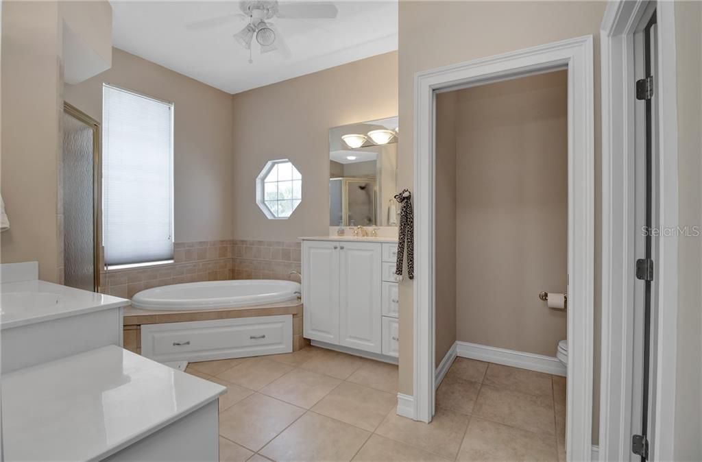 Master bath with private toilet area, jetted tub and dual sinks