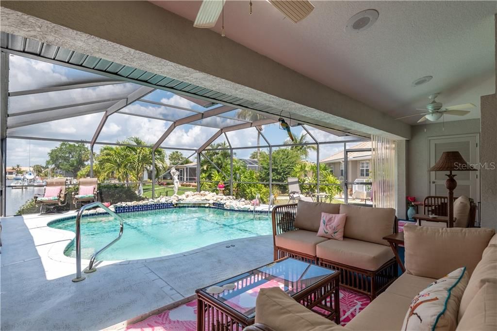 Pool / Lanai  with ceiling fans, storage closet, hurricane shutters AND a beautiful long water canal view