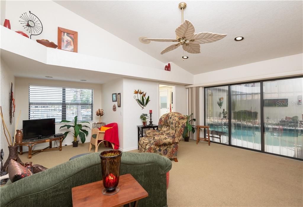 Family Room features sliding glass doors to the lanai/pool