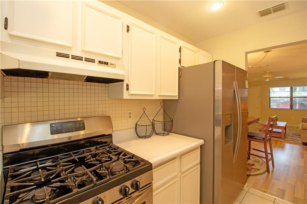 kitchen with 6 burner gas range.  Newer Stainless Steel refrigerator.