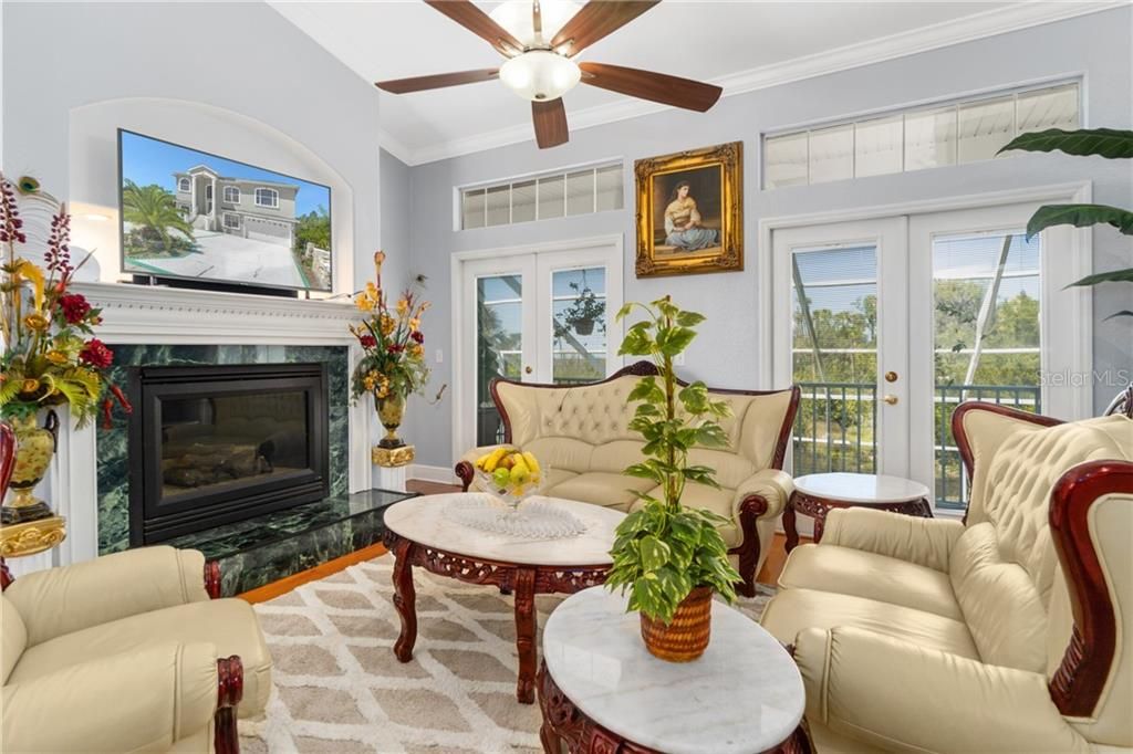 Family Room with Gas Fireplace and French Doors to Upper Balcony