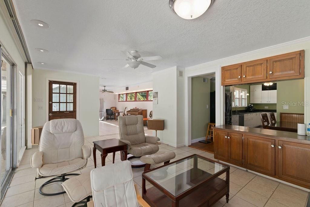 Family room with views into kitchen and breezeway.