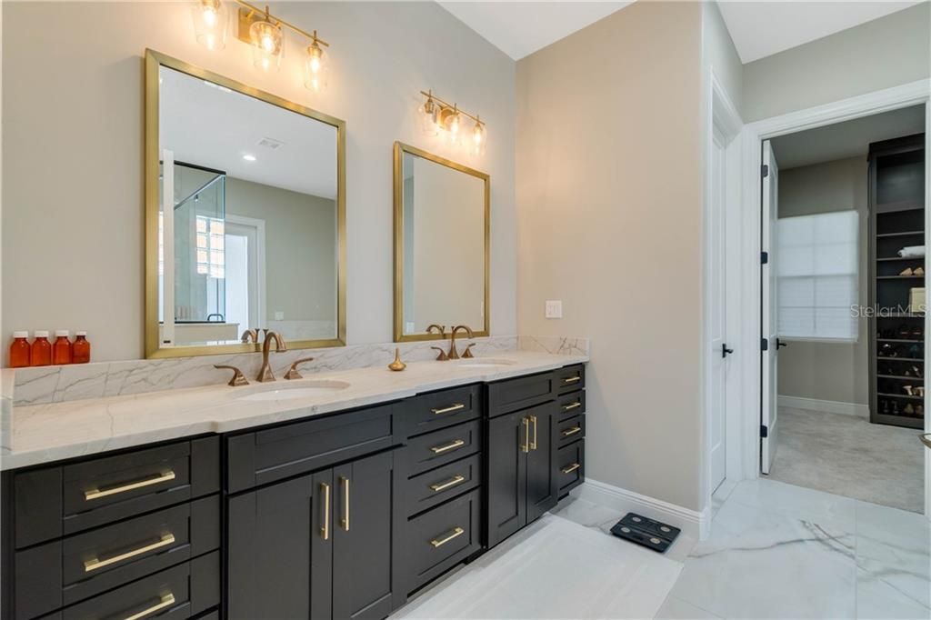 Contemporary master bath with double sinks, soaking tub, large shower and custom built in closet.