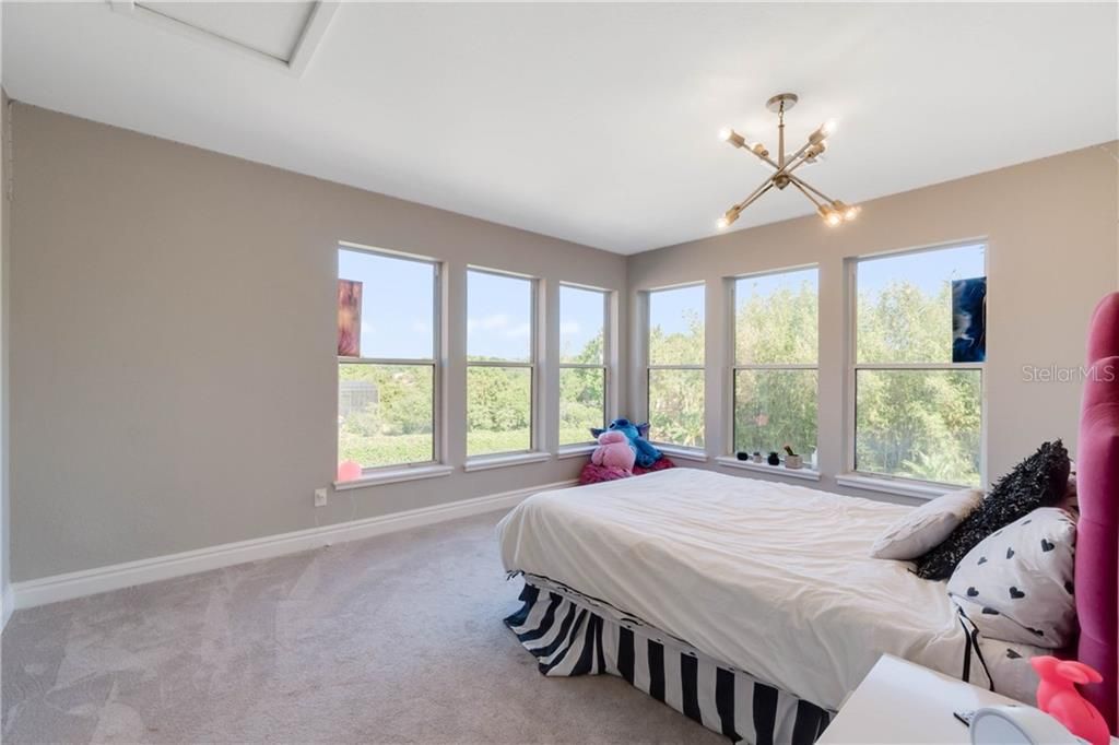 Gigantic fourth bedroom features the MOST AMAZING SUNSET VIEWS!  Has private ensuite bath and walk in custom closet.