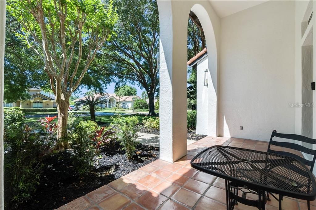 Inviting front porch... jump in your golf cart and get to the Bay Hill Club in 7 minutes all on community streets.