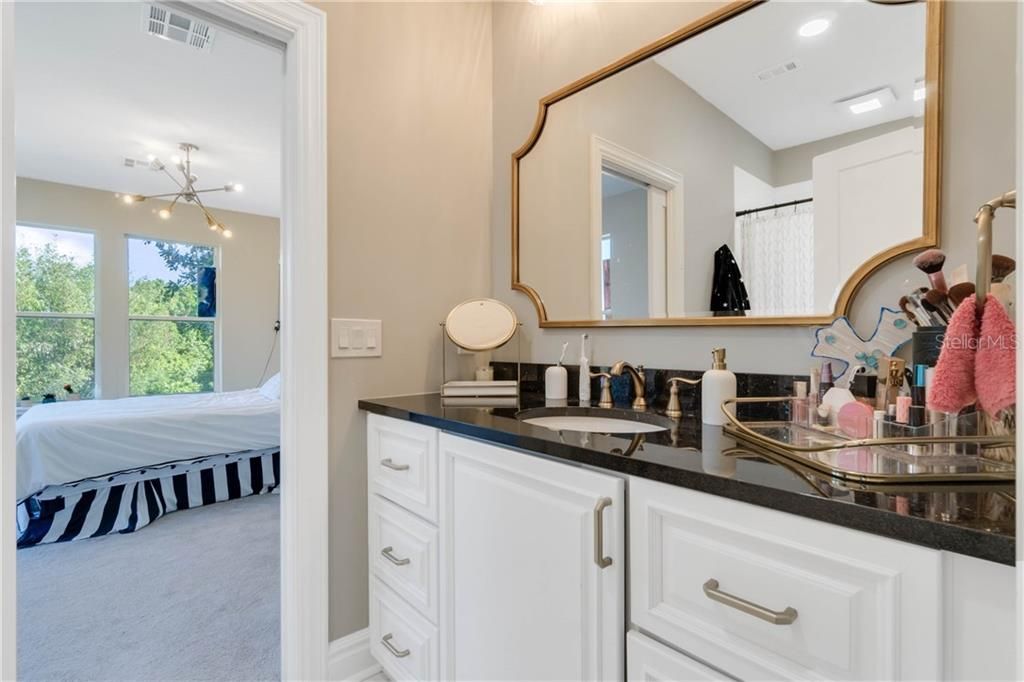 Fashionably remodeled bathroom is private to large fourth bedroom