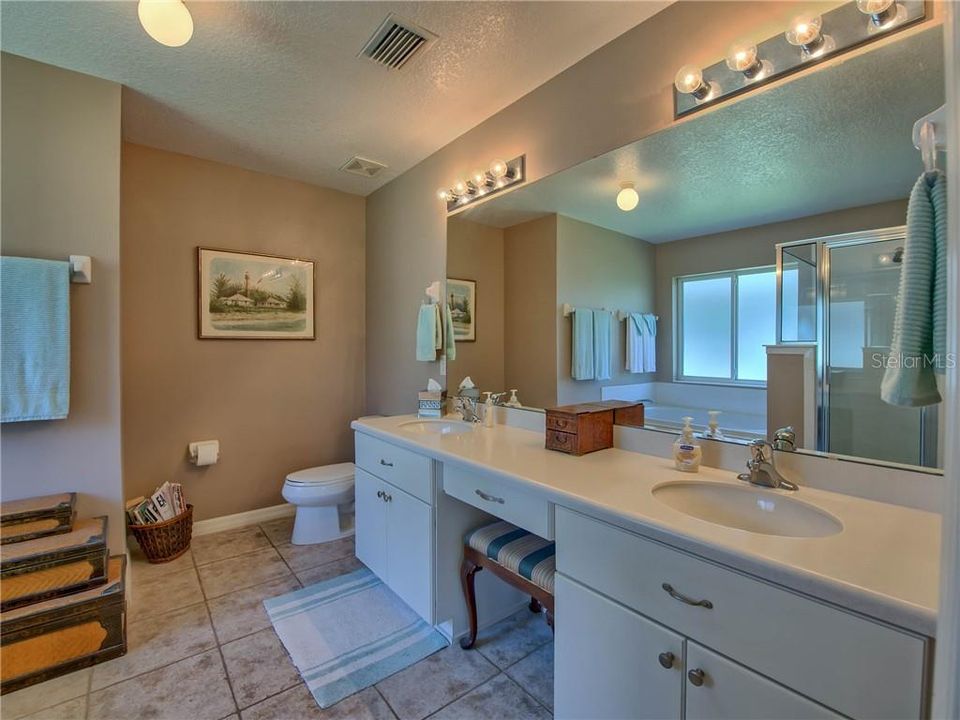 Oversized dual vanity features corian counters, china undermount sinks and make-up area!