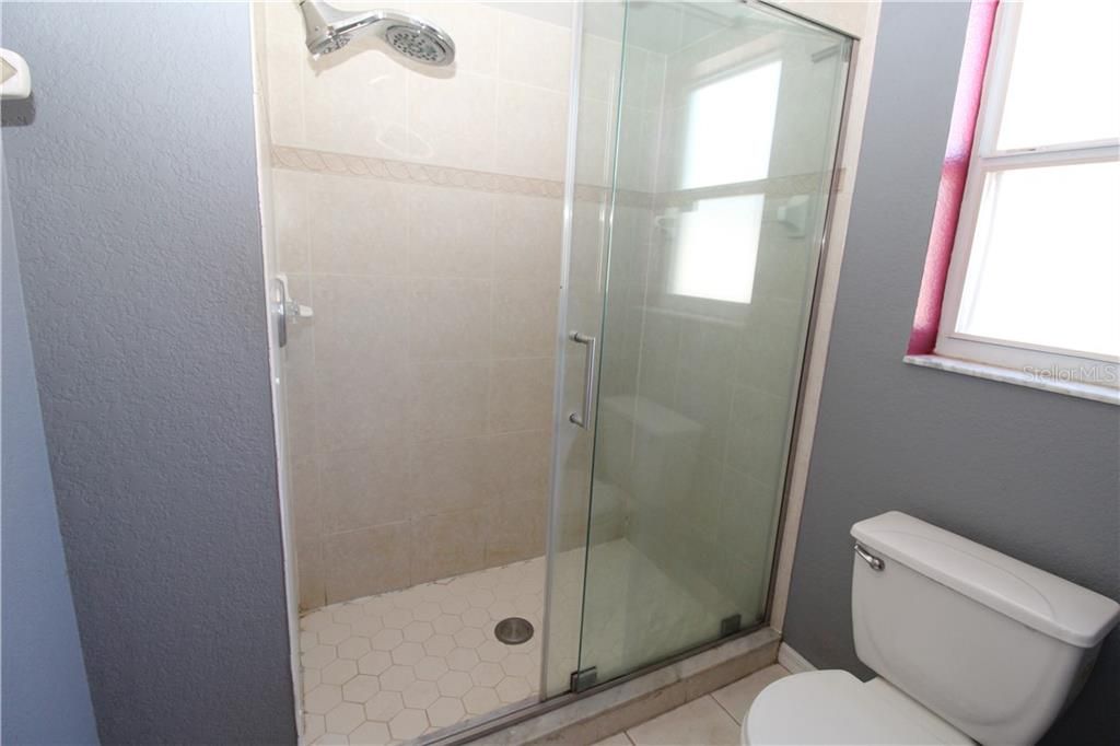 Master Bathroom Walk-in shower with sliding glass doors.