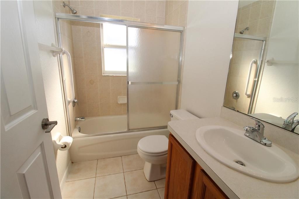 Guest Bathroom with tub/shower.  Nice tiles on wall in shower.