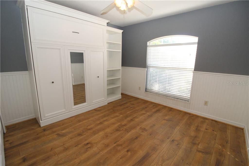 Bedroom #3  with newer laminate wood flooring and Murphy Bed will stay with house...