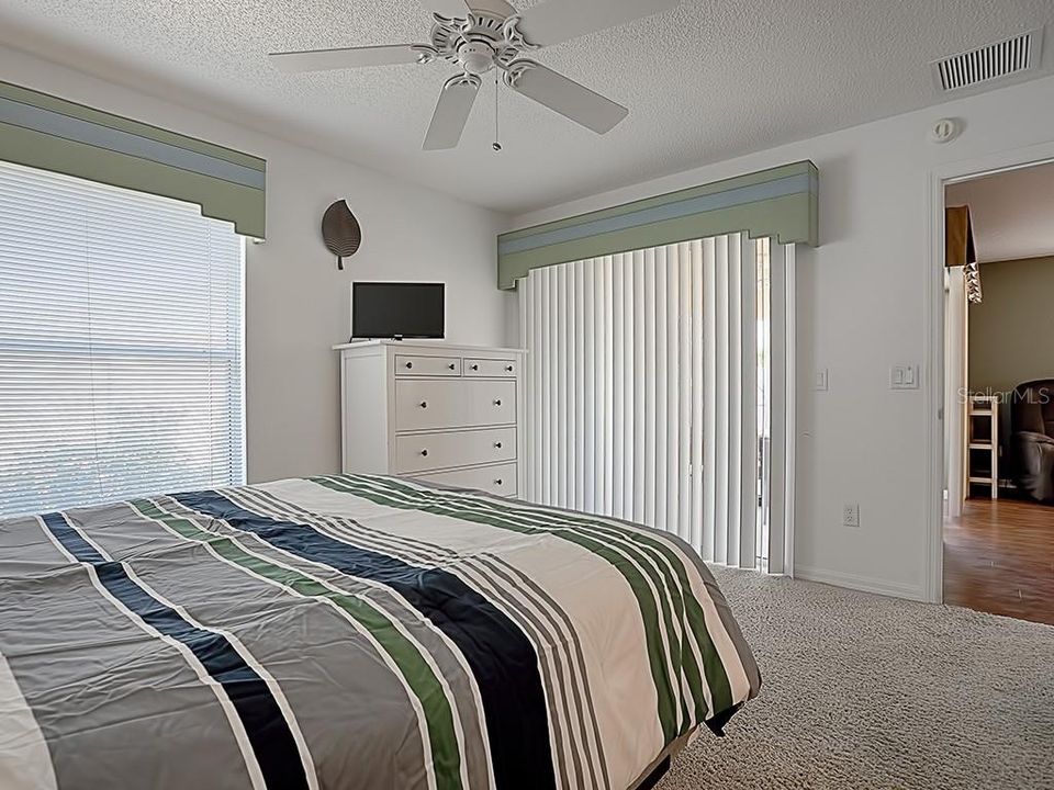 YOUR MASTER BEDROOM ALSO HAS SLIDING GLASS DOORS LEADING TO YOUR SCREENED LANAI.