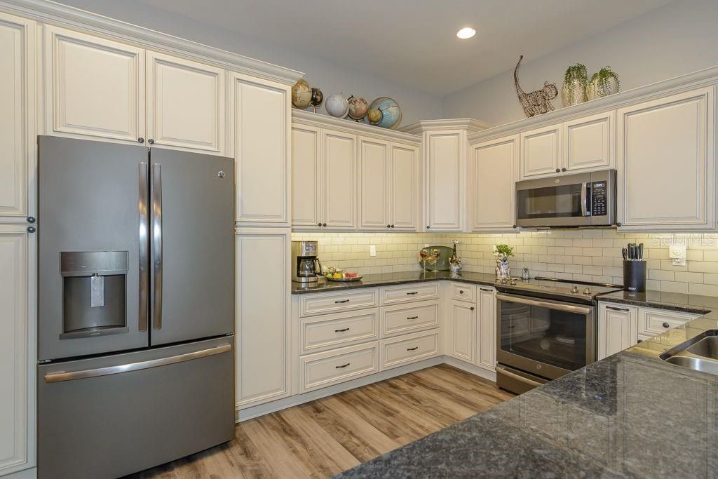 The kitchen features solid wood soft-close cabinets, granite counter tops and stainless steel appliances.