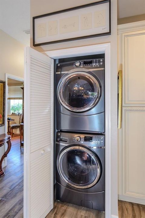 A full sized stackable washer and dryer are located in a closet right beside the kitchen.