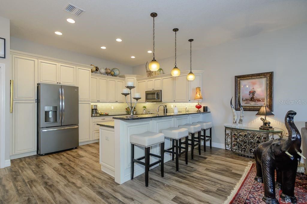 The kitchen offers a breakfast bar for a casual dining option.