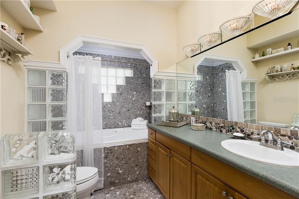 Elegant Master bath with Jacuzzi tub/shower combo, vanity and walk-in closet
