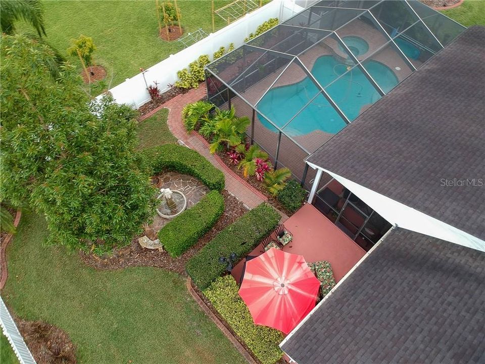 CLOSEUP AERIAL VIEW OF FOUNTAIN, POOL AND OUTSIDE GRILL AREA