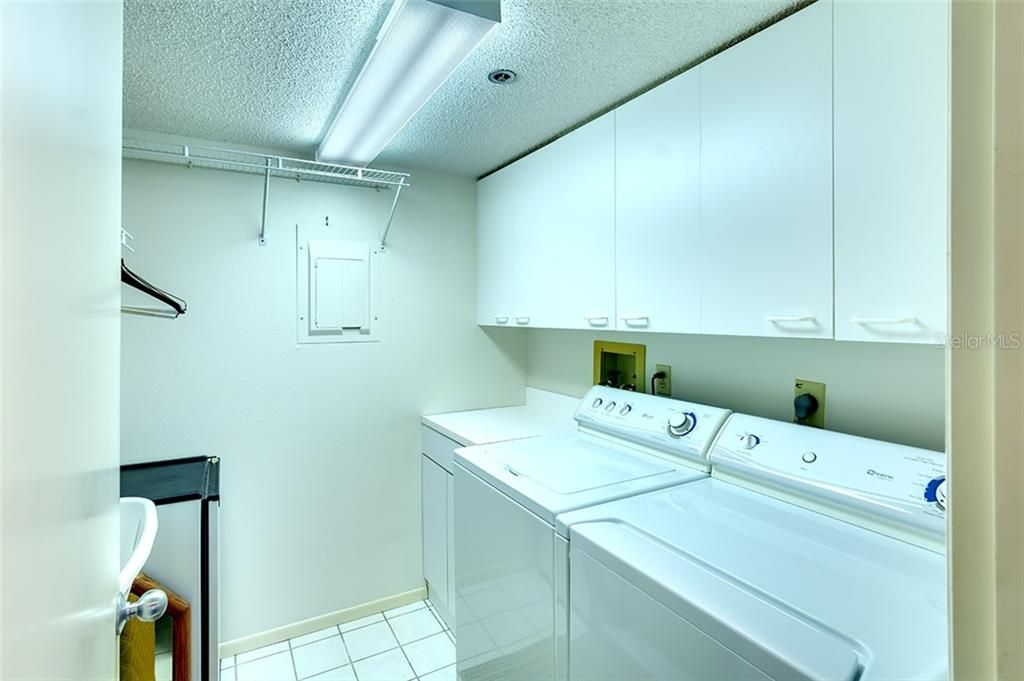 Look at all the cabinet space in the indoors laundry room.
