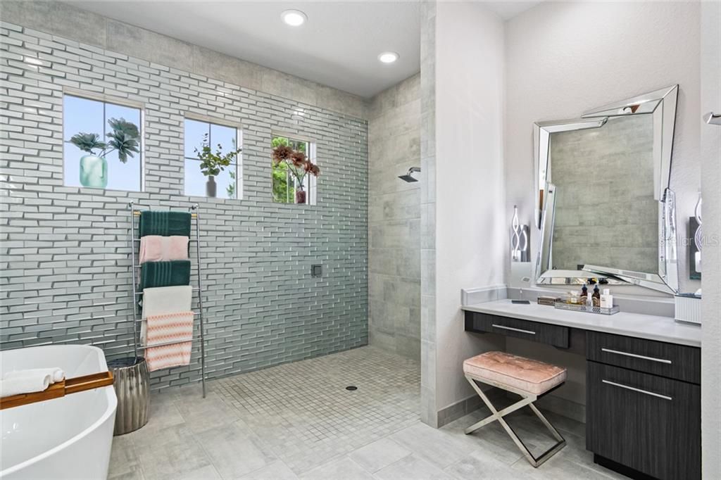 Master Bathroom with Oversized Shower and built in Vanity with cabinets custom for makeup and hair tools