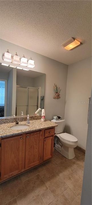 Tiled Master bath with granite counter
