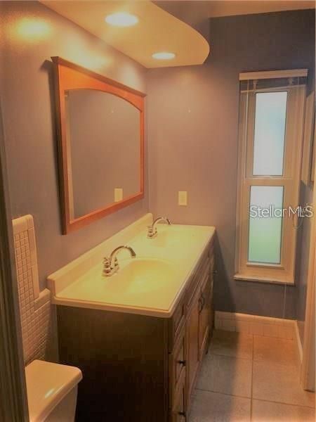 The master bathroom features double sinks, a walk in shower and natural lighting.