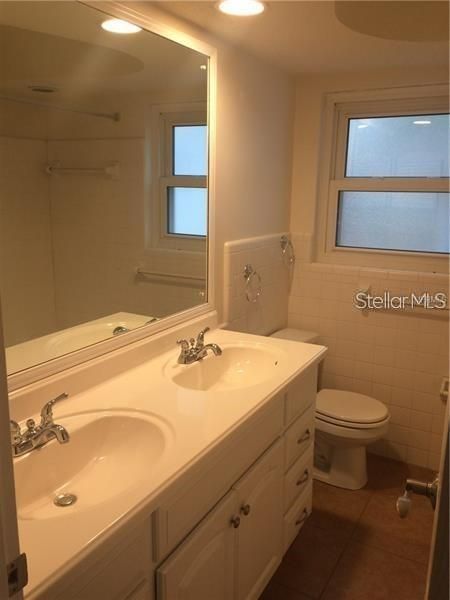 The second bathroom features double sinks, tub and shower.