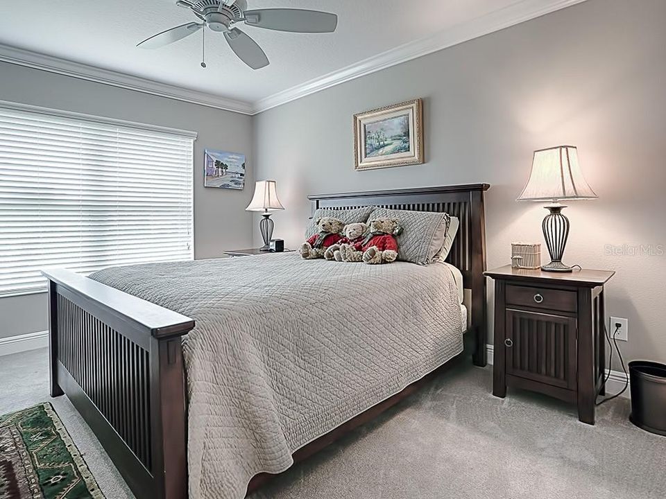 FRONT GUEST BEDROOM WITH CROWN MOLDING AND CARPET.
