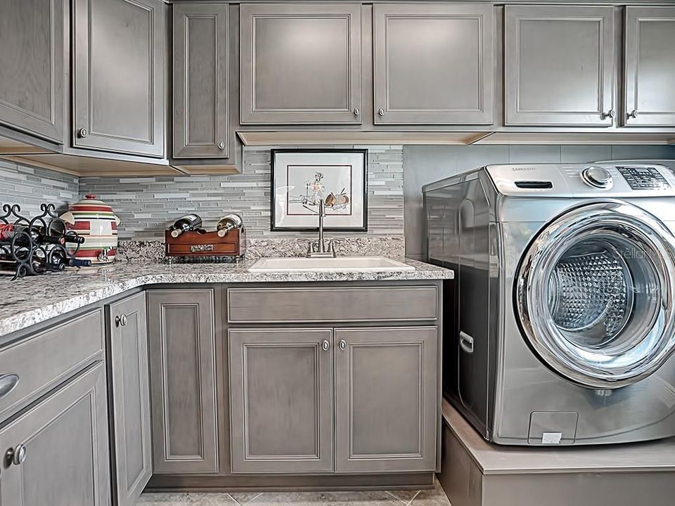 SO MUCH EXTRA STORAGE IN THE BUTLERS PANTRY AND LAUNDRY ROOM WITH BUILT IN PEDESTAL FOR YOUR WASHER/DRYER!