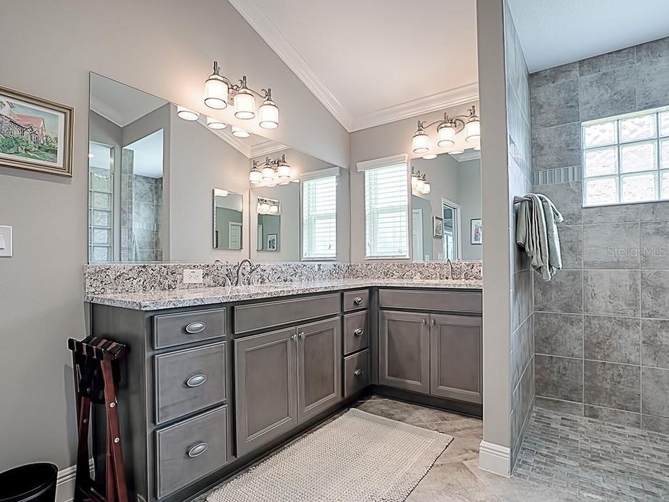 GRANITE COUNTERS WITH HIS AND HER SINKS AND ROMAN SHOWER IN THIS MASTER BATH!