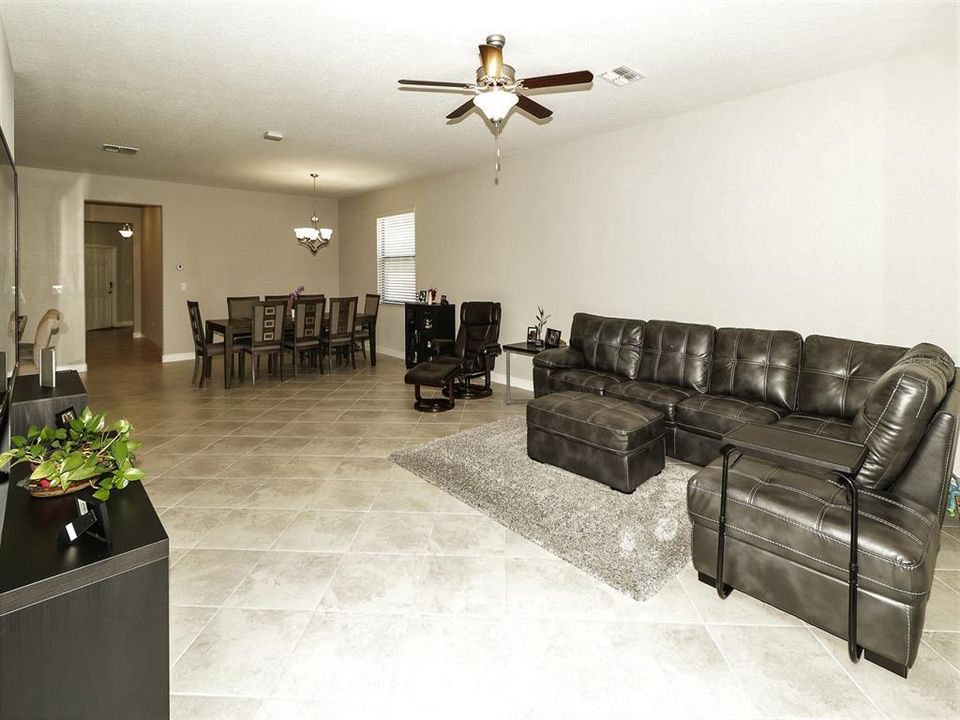 Living room dining room combination with  ceramic tile floor.