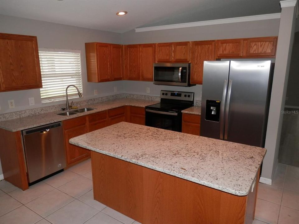 Updated Kitchen with All NEW Stainless Steel Appliances, NEW Granite Counters, NEW Under Mount Stainless Sink,NEW Faucet, NEW Garbage Disposal And NEW Island Bar