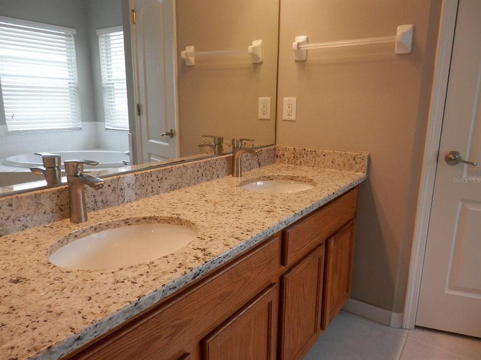 The master bath includes vanity with new granite counter with dual under mount sink vanity with new faucets. New vanity lights, new toilet as well.  Garden tub plus separate shower with glass enclosure. Privacy prevails with separate water closet too.